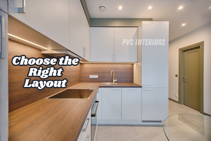 Modern PVC modular kitchen layout designed by PVC Interiors in Bengaluru, featuring sleek white cabinets and wood finish